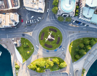 Aerial view of cars moving through a modern roundabout.