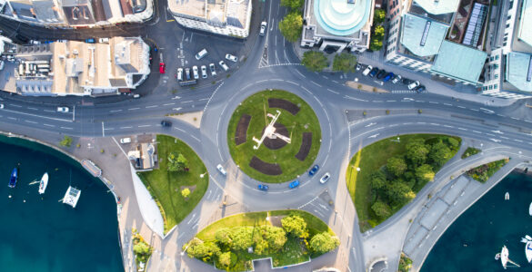 Aerial view of cars moving through a modern roundabout.