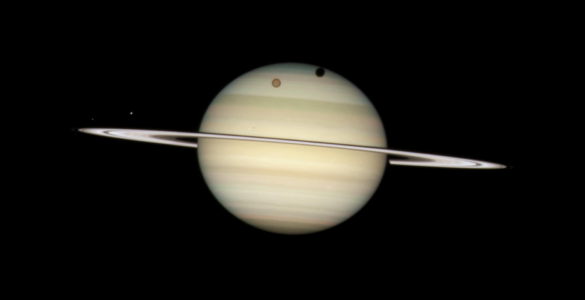 Saturn seen with its rings tilted at a shallow angle against black space