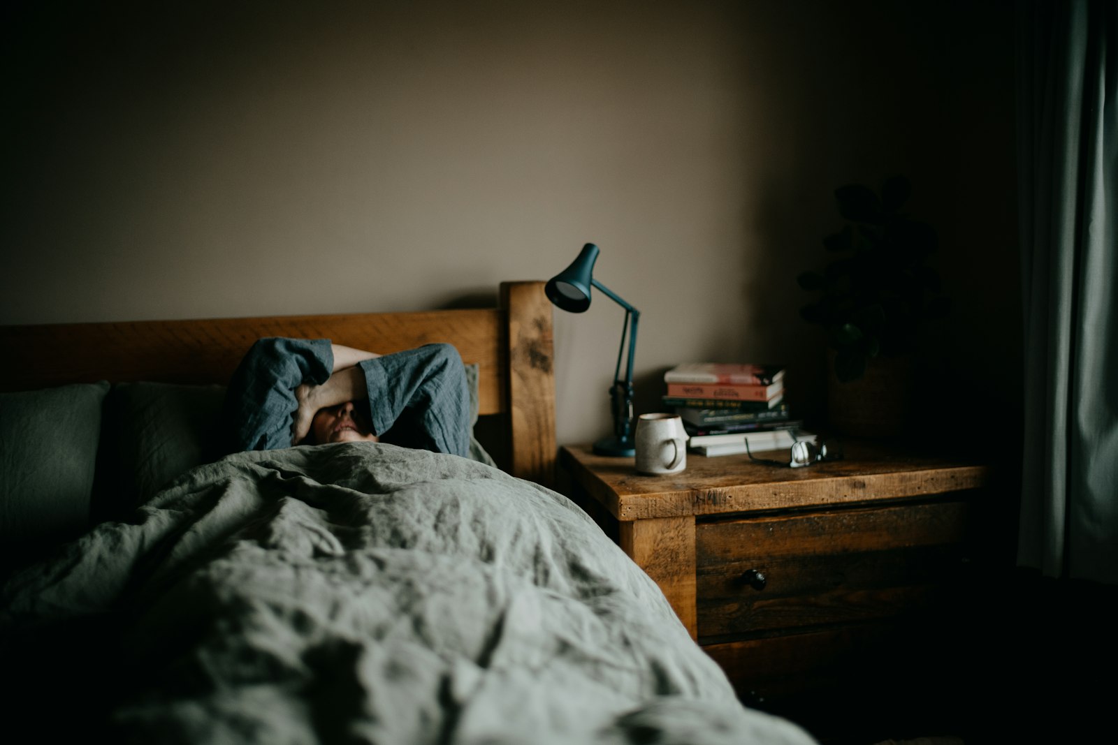 A person resting in bed, representing the transition from sleep to waking.