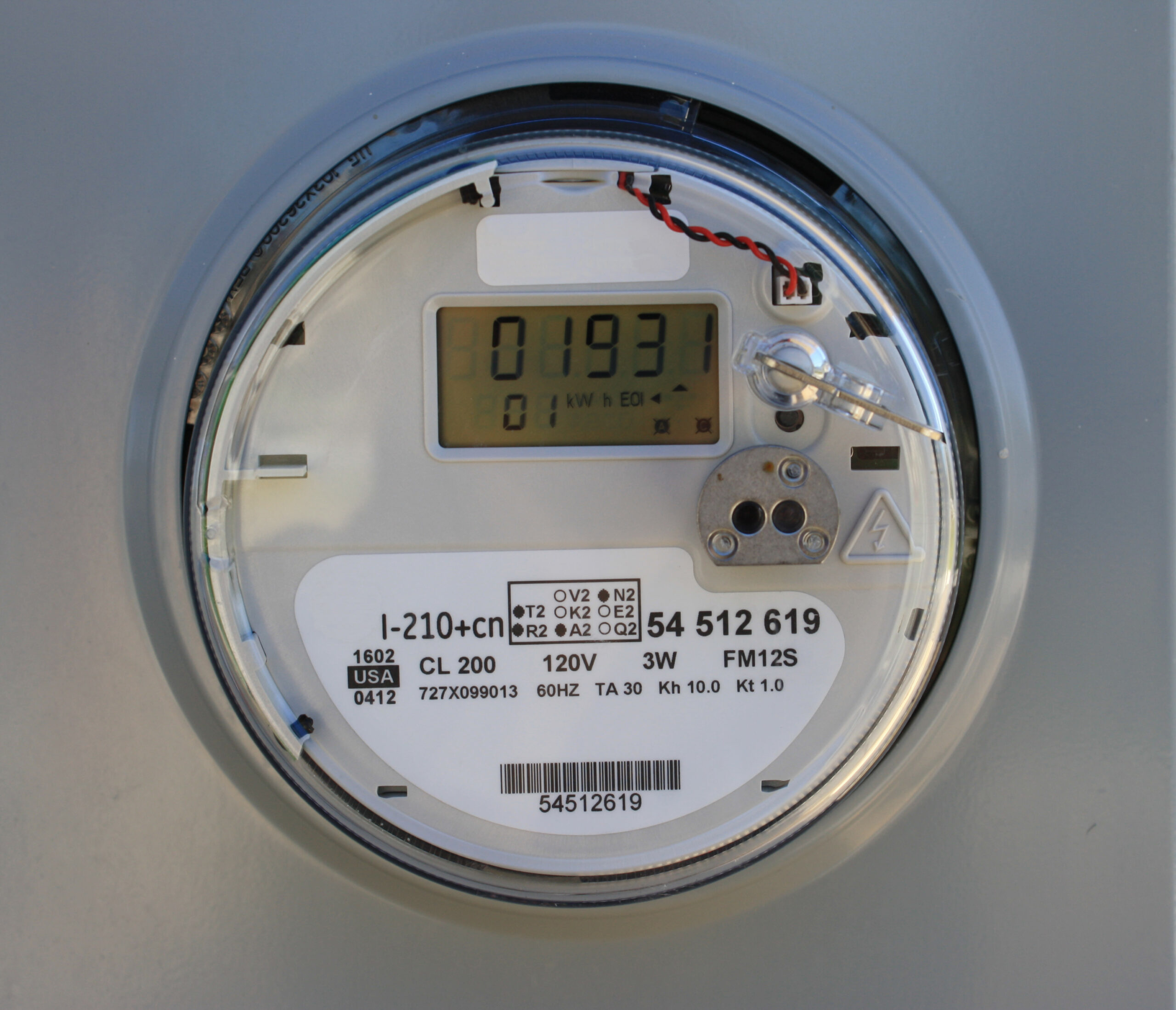 A smart electric meter mounted outside a home for recording electricity use.