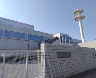 A coastal submarine cable landing station where undersea fiber-optic cables connect to land networks.
