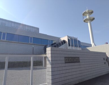 A coastal submarine cable landing station where undersea fiber-optic cables connect to land networks.