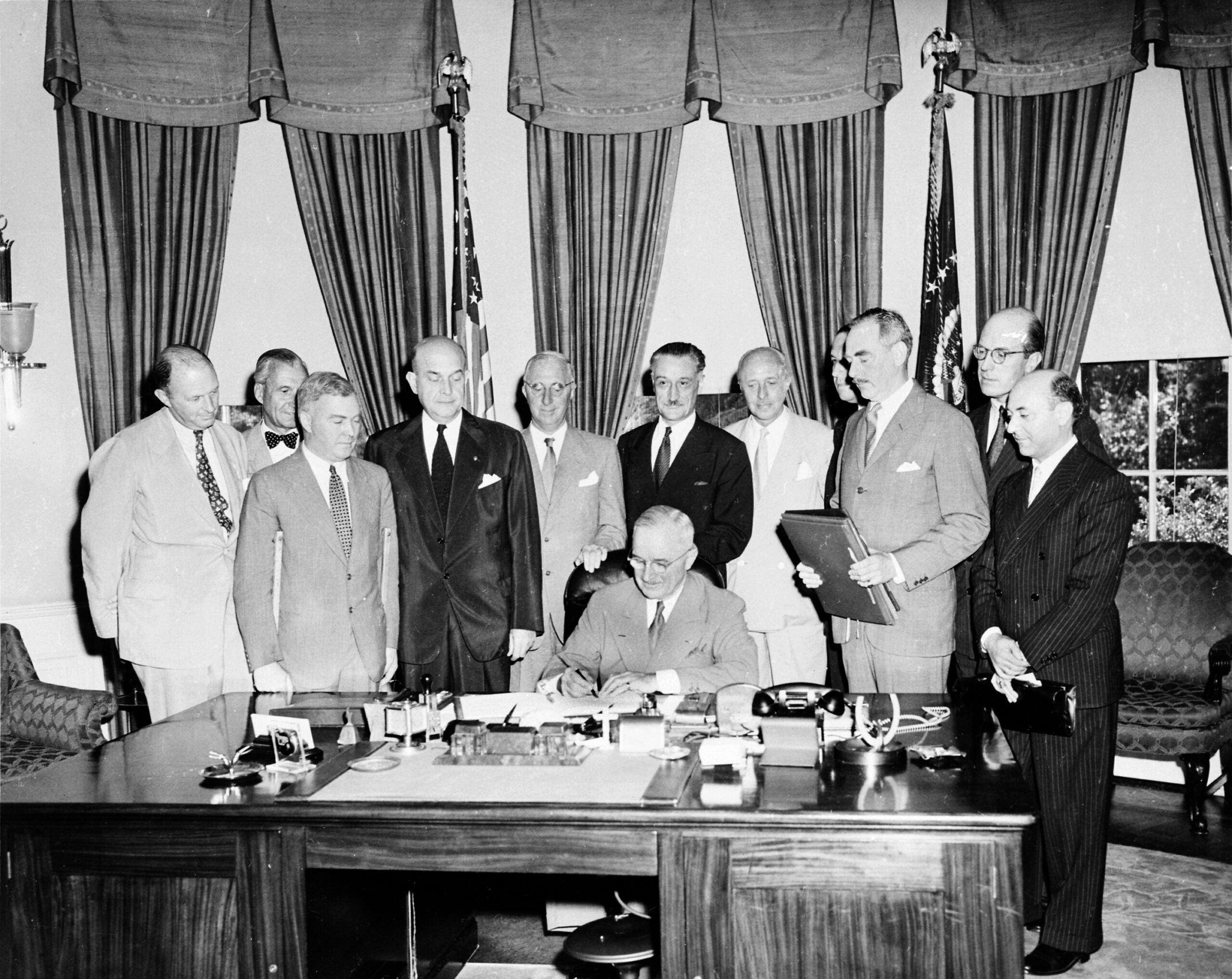 President Harry Truman signing the document implementing the North Atlantic Treaty in 1949