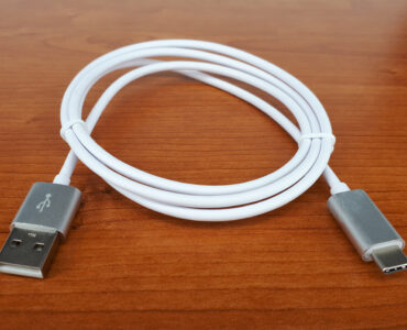 A USB-C cable coiled on a plain surface for charging and data connections