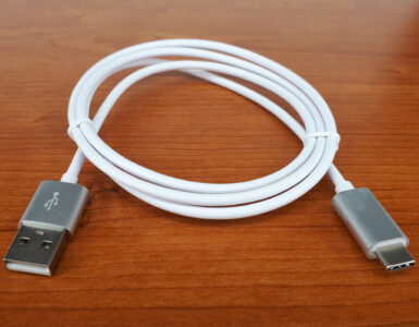 A USB-C cable coiled on a plain surface for charging and data connections