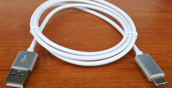 A USB-C cable coiled on a plain surface for charging and data connections