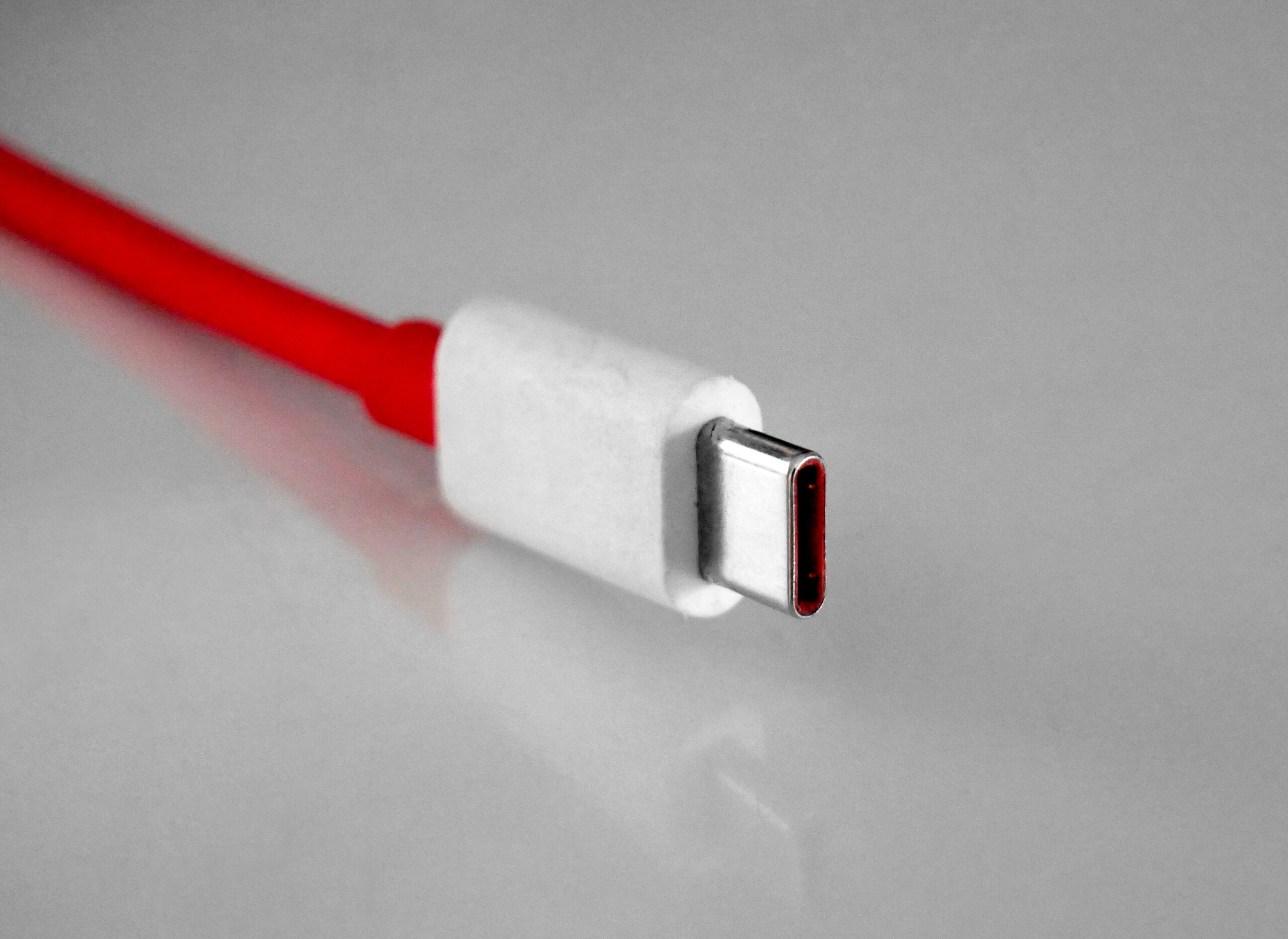Close-up view of a USB-C plug showing its small reversible connector shape