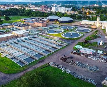 Aerial view of a wastewater treatment facility where community wastewater can be sampled for public health monitoring.