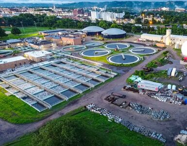 Aerial view of a wastewater treatment facility where community wastewater can be sampled for public health monitoring.