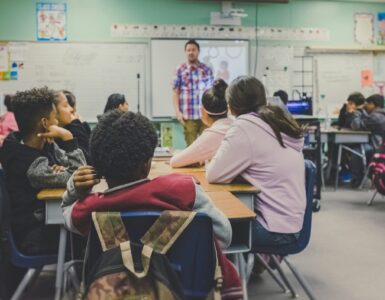 Students listening in a classroom where support plans can help learning needs and access stay visible.
