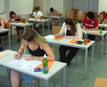 Students taking a standardized test, representing ACT Science practice focused on reading data and evidence.