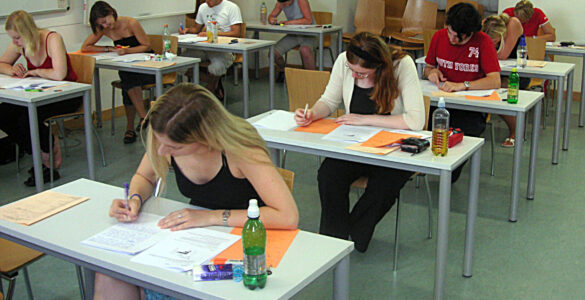 Students taking a standardized test, representing ACT Science practice focused on reading data and evidence.