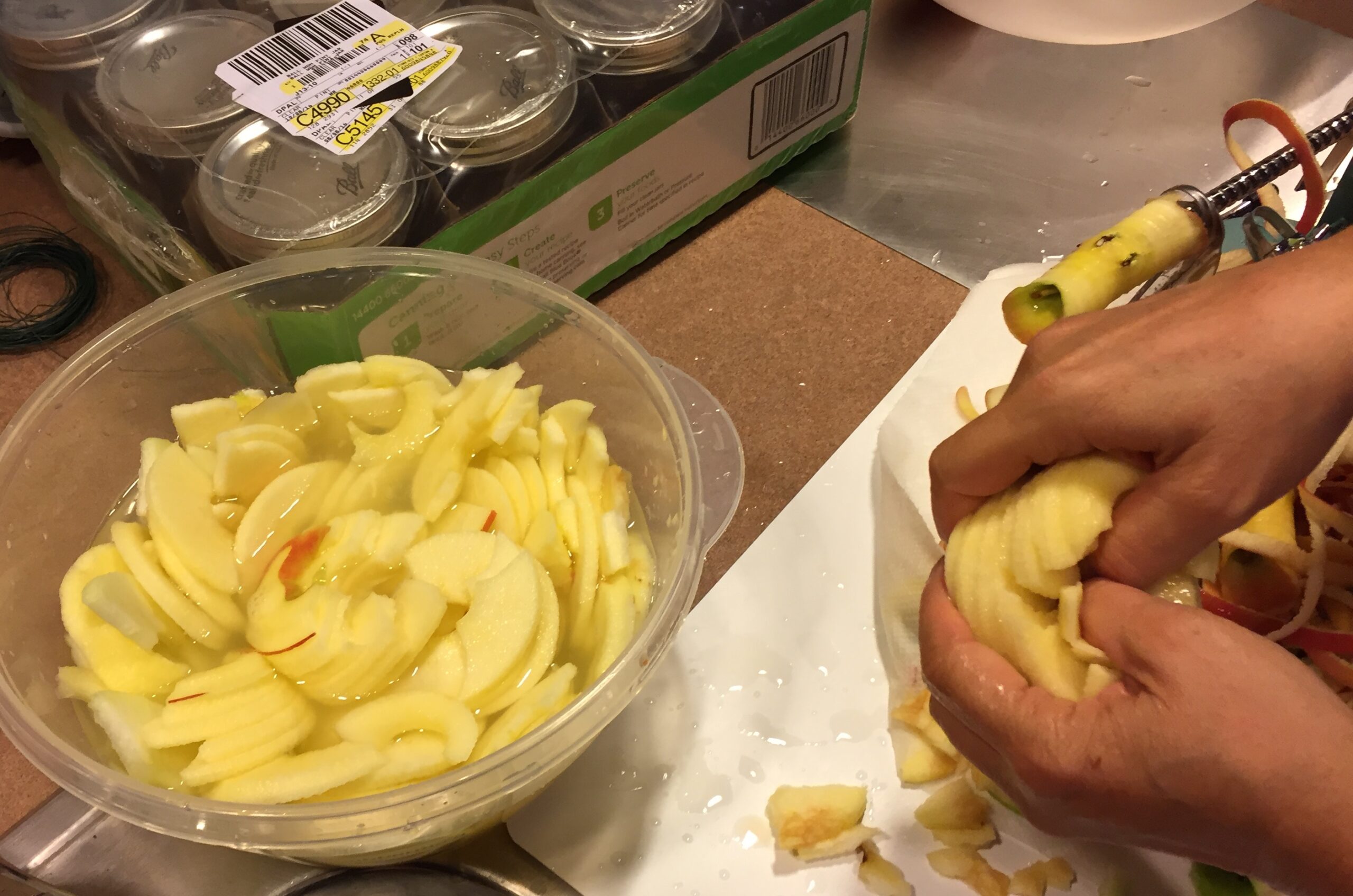 Apple slices soaking in liquid during food preparation to help limit enzymatic browning.