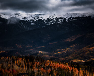 Autumn-colored hills and mountains under clear daylight