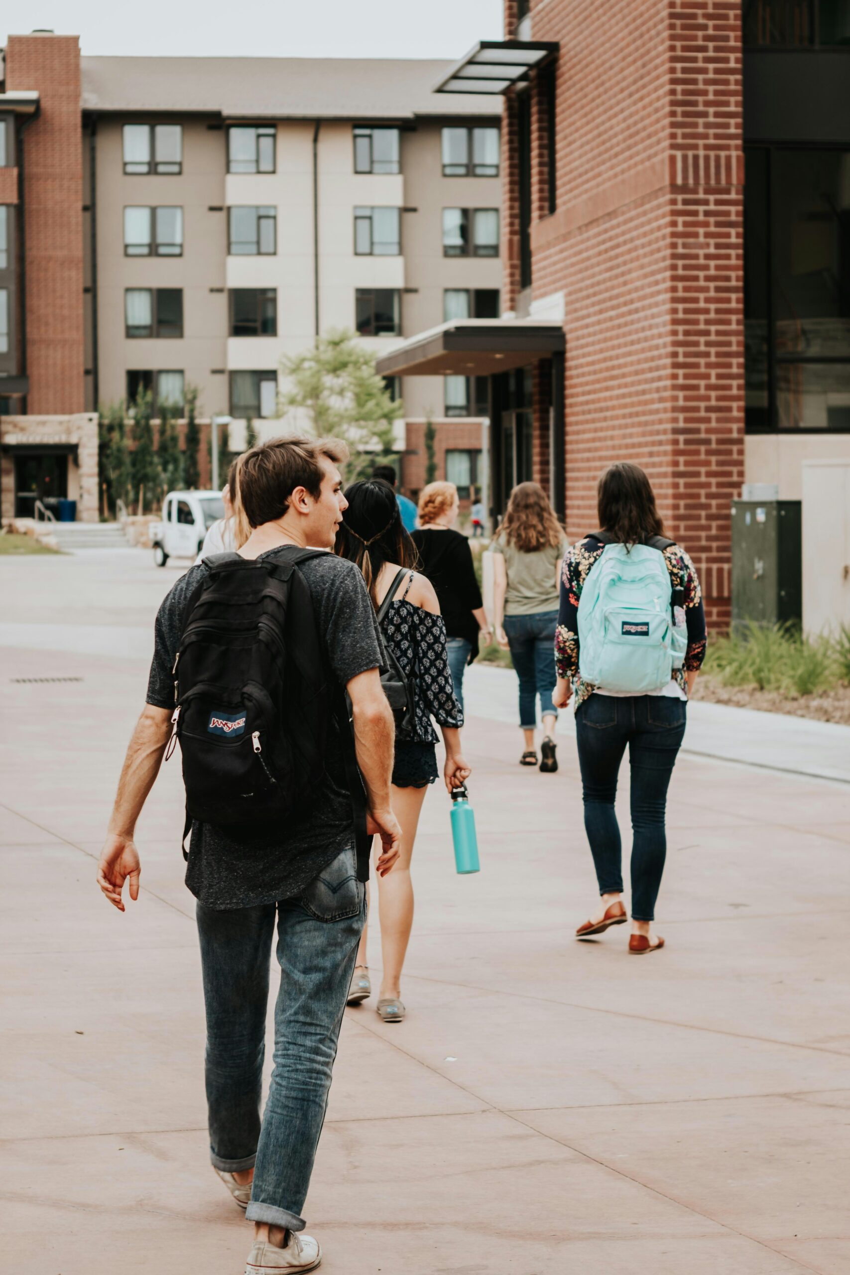 Students walking across campus, representing the extra time needed when parking is farther from class.