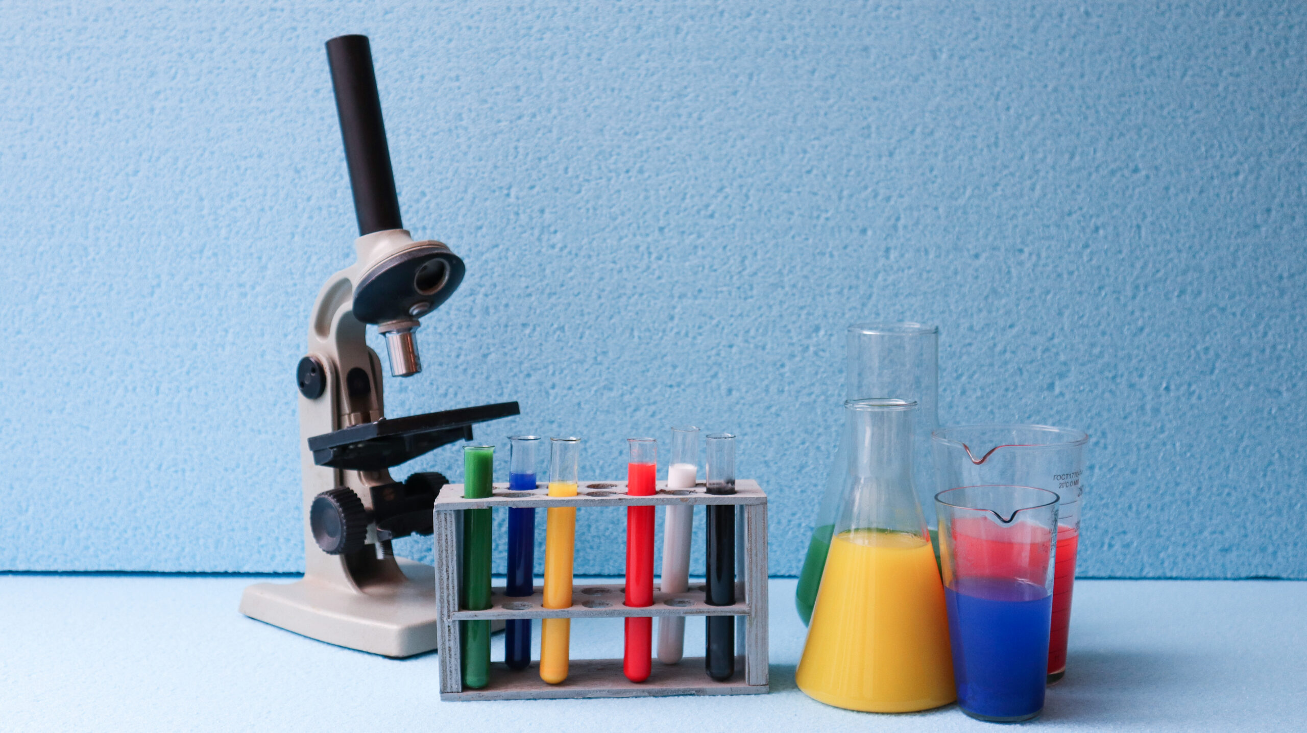Laboratory glassware with colored liquids, representing the need to connect chemical labels with safety data sheet information.