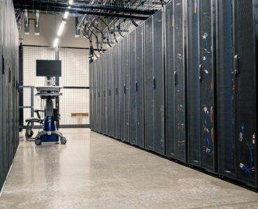 Rows of server racks representing the remote computing resources behind cloud services.