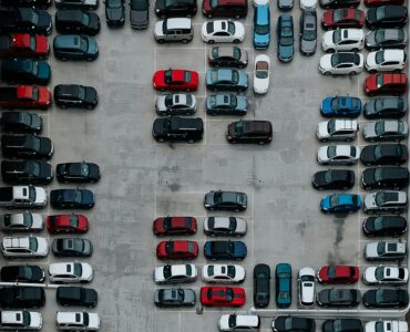 A crowded parking lot seen from above, showing why campus parking permits do not always mean an open space.