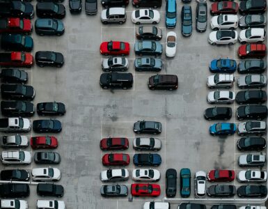 A crowded parking lot seen from above, showing why campus parking permits do not always mean an open space.