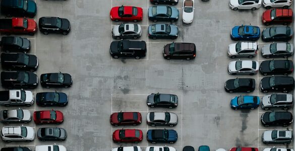 A crowded parking lot seen from above, showing why campus parking permits do not always mean an open space.