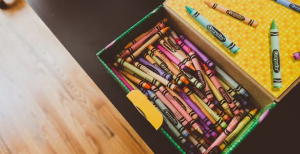 A box of colorful crayons ready for drawing, showing the wax sticks used to leave color on paper.