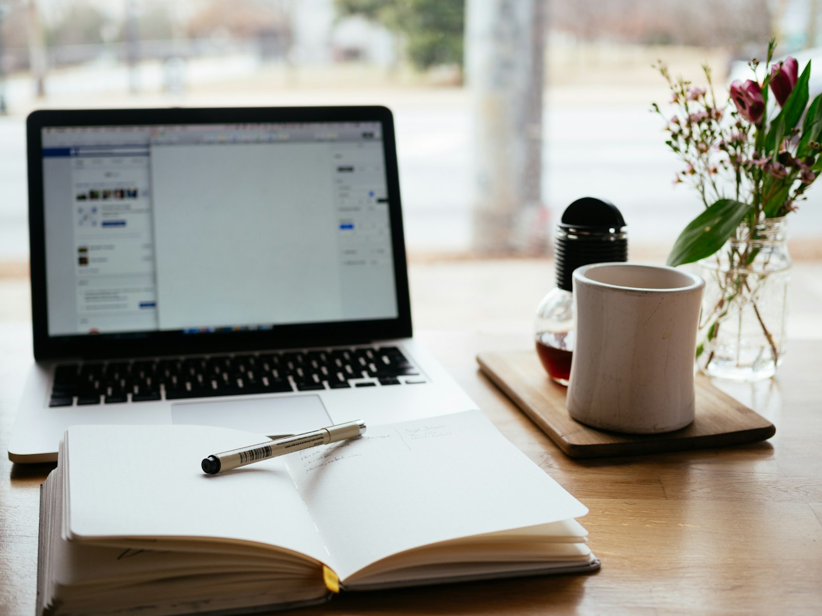 A notebook and laptop used to compare credit hours before a college census date