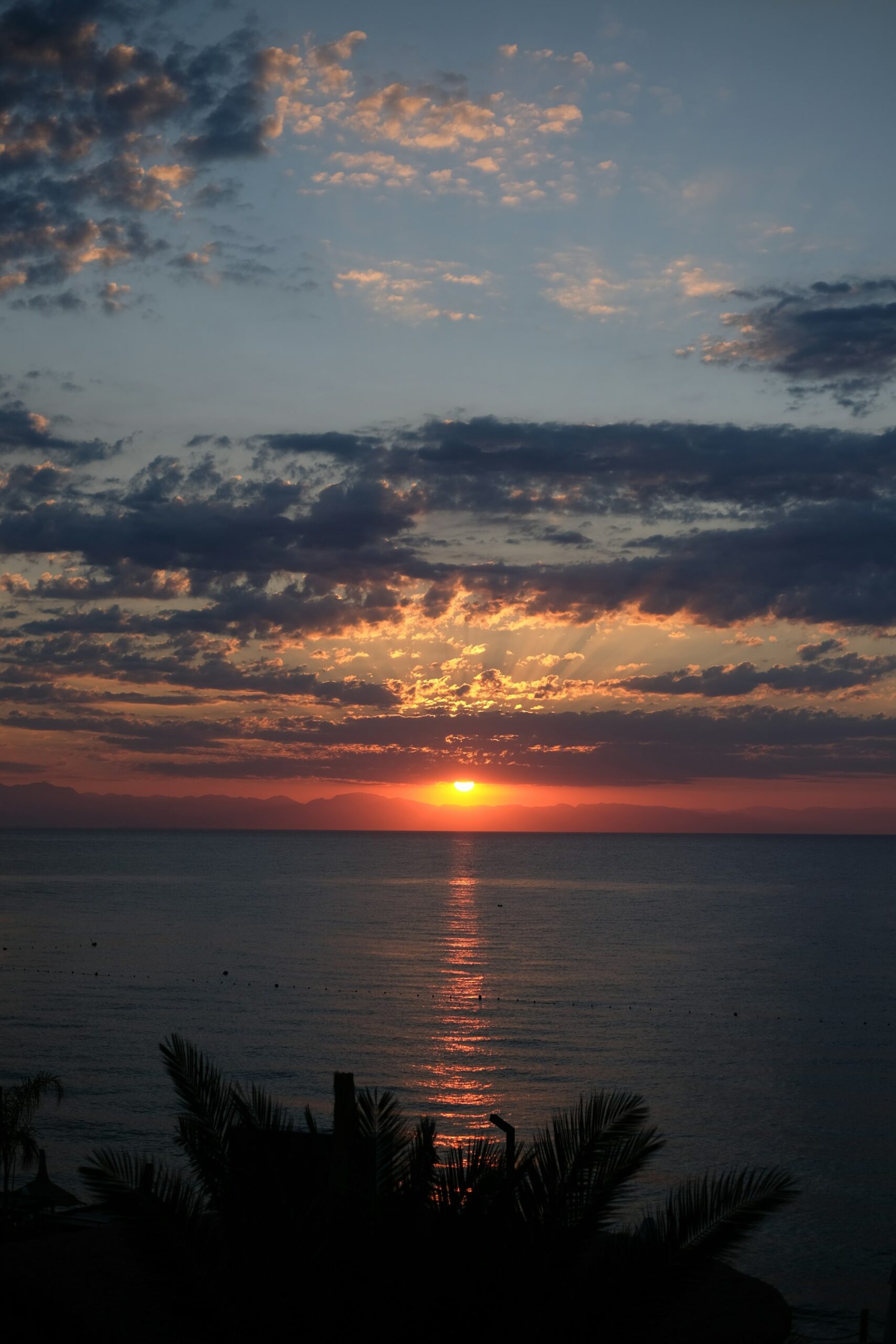 The Sun setting near a flat horizon, showing how daylight shifts relative to clock time