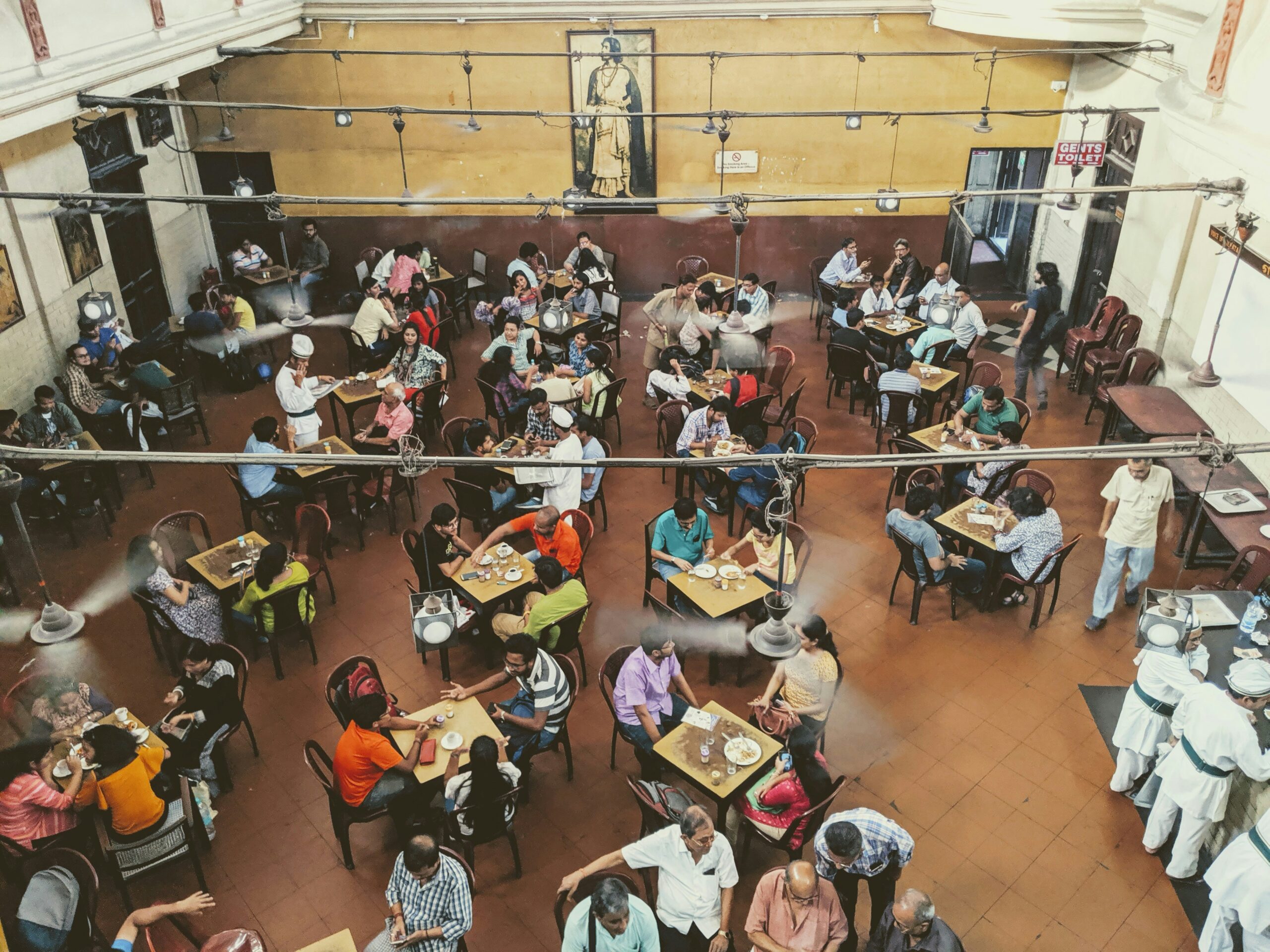 Students in a dining hall, representing how spacing and service capacity affect waiting time.