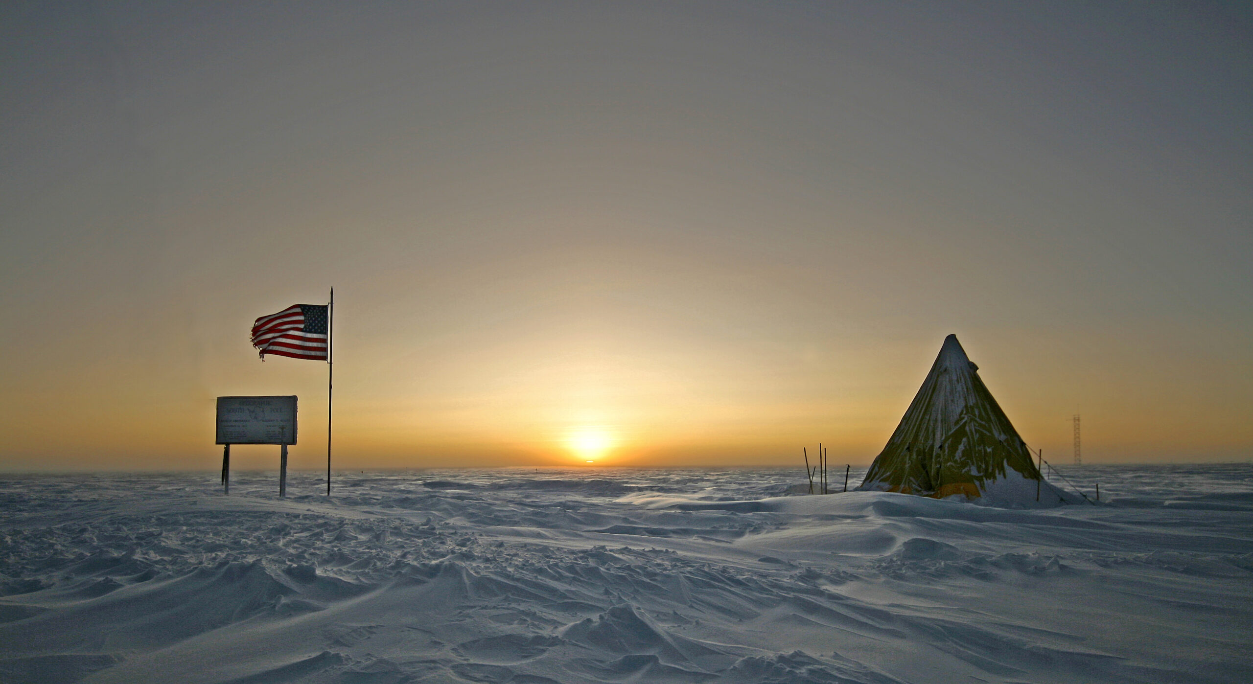 The Sun rises low over the snowy horizon near the South Pole around the September equinox.