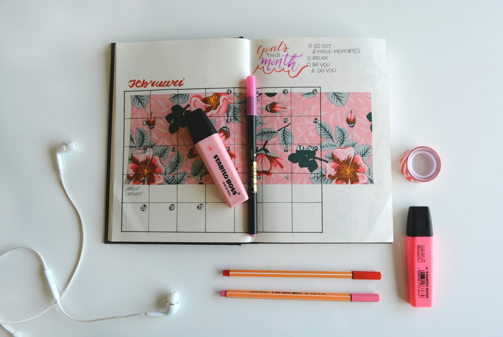 A study planner and school supplies arranged on a desk, representing pen choices that depend on ink chemistry and temperature.