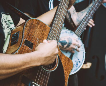 Close-up of a musician playing an acoustic guitar