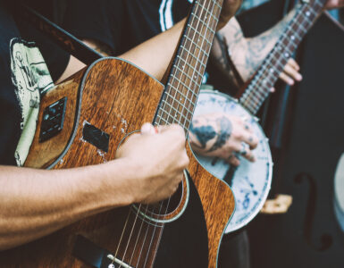 Close-up of a musician playing an acoustic guitar