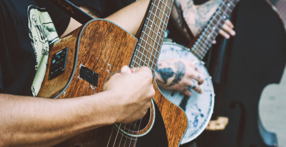 Close-up of a musician playing an acoustic guitar