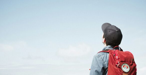 A student wearing a backpack, showing how a school bag shifts weight behind the body