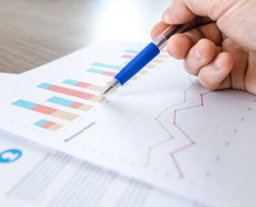Printed data charts representing how a histogram groups numerical values into intervals to show distribution shape.