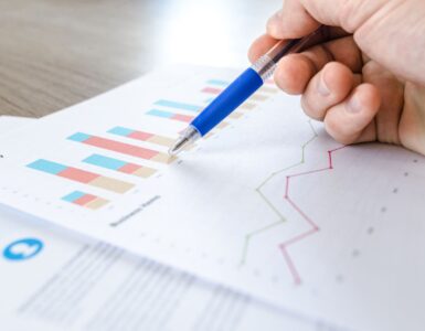 Printed data charts representing how a histogram groups numerical values into intervals to show distribution shape.