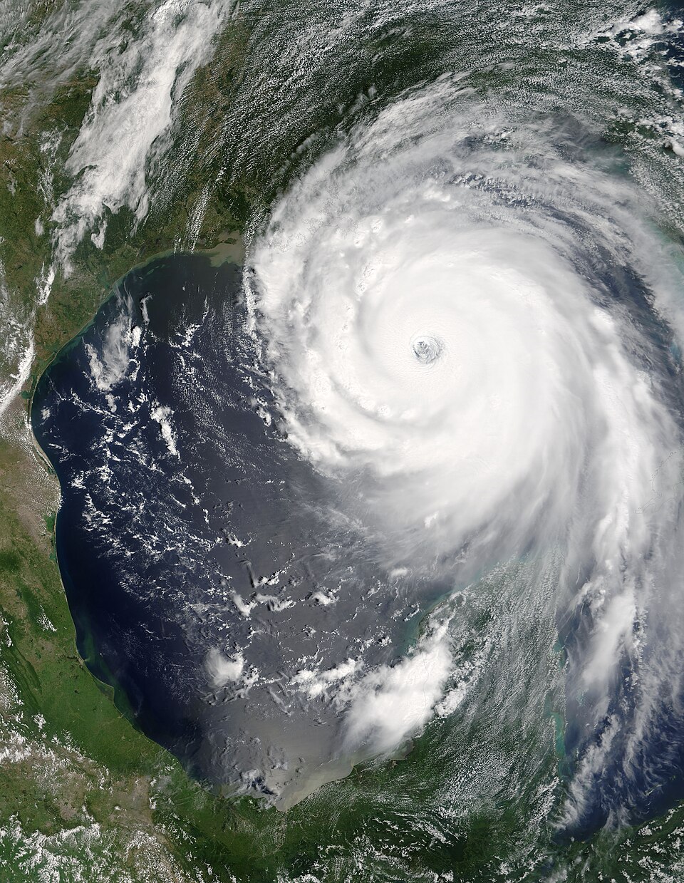 Satellite image showing an organized hurricane over warm ocean water with a visible eye and spiral rainbands.