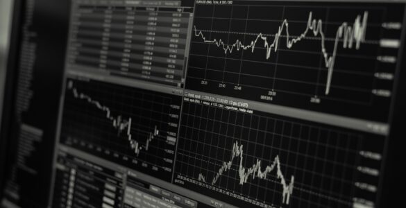 A computer monitor showing stock market charts and price lines.