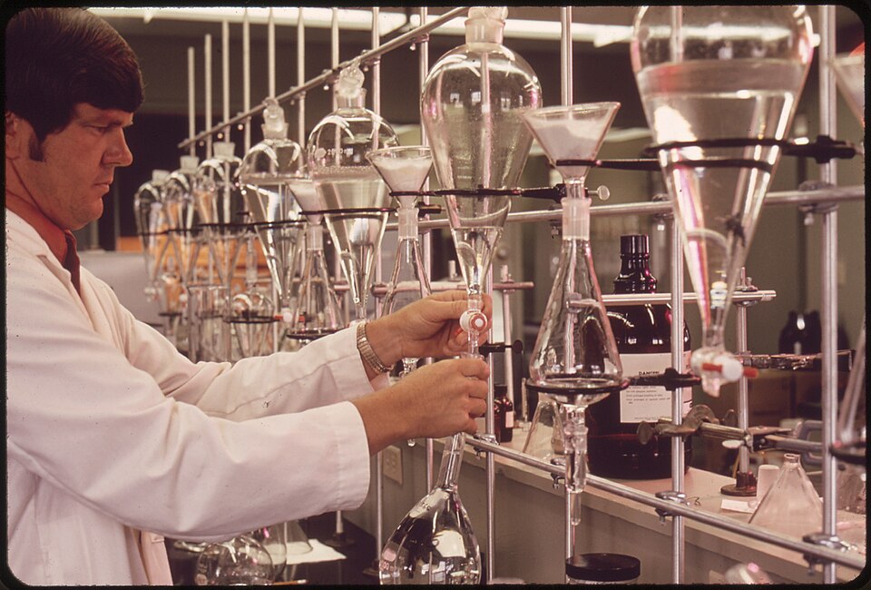 A laboratory worker testing samples, representing the surveillance used to track changing influenza viruses.