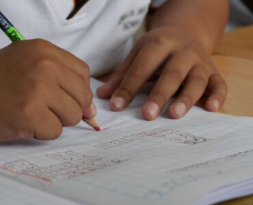 A student uses graph paper and a number line to practice writing interval notation.