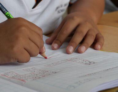 A student uses graph paper and a number line to practice writing interval notation.