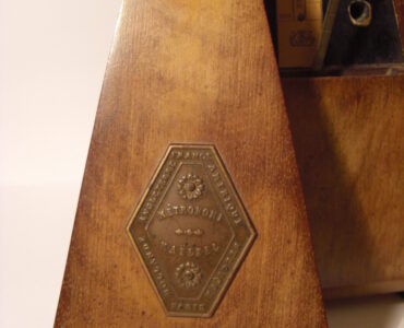 A mechanical metronome used to keep a steady beat during music practice.