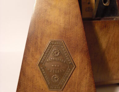 A mechanical metronome used to keep a steady beat during music practice.