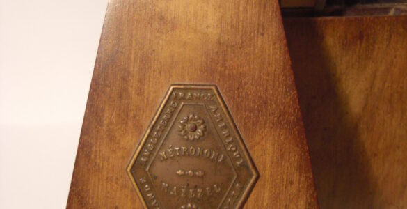 A mechanical metronome used to keep a steady beat during music practice.