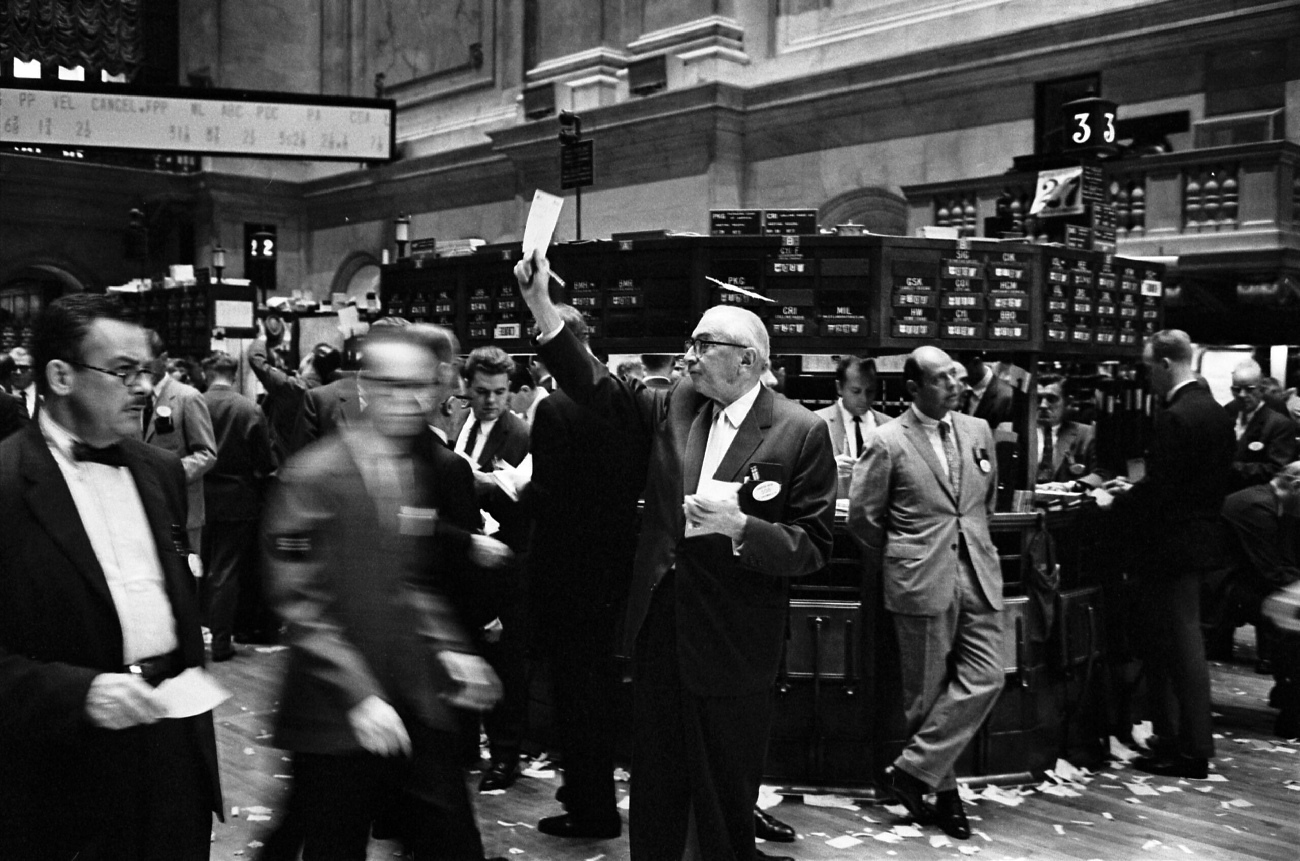 Stock brokers working on the New York Stock Exchange trading floor in 1963.