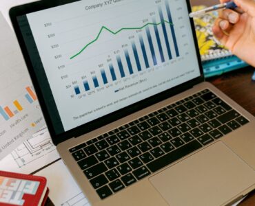 A laptop screen with charts, representing how percentage points and percent change can tell different stories in data.