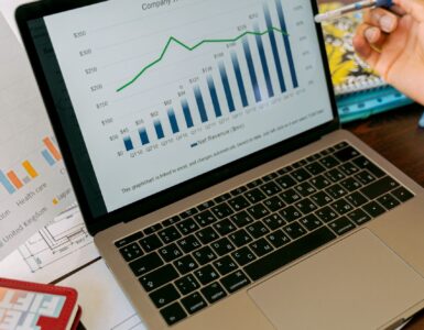 A laptop screen with charts, representing how percentage points and percent change can tell different stories in data.