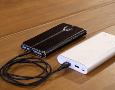 A smartphone charging from a portable power bank, representing how rechargeable batteries lose capacity over time.