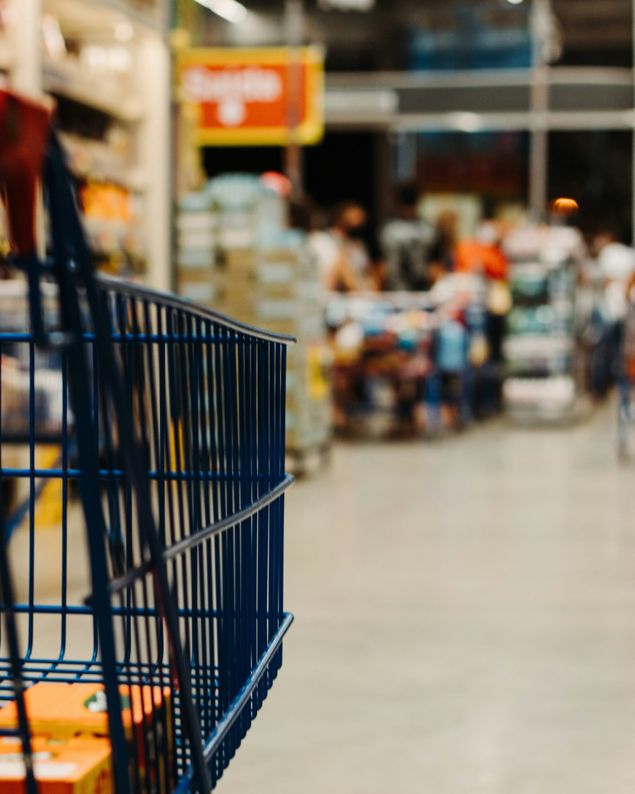 A grocery aisle where shoppers compare prices before deciding what to buy.